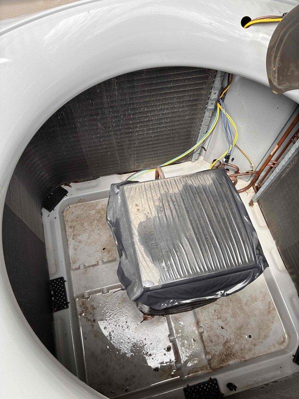 Completed comprehensive HVAC tune-up service on residential system. Inspected indoor evaporator coil compartment, noting moderate dust accumulation on finned heat exchanger and debris buildup in drain pan with visible moisture staining. Examined outdoor condenser unit coil fins, which showed dirt and environmental debris accumulation between fin spacing. Documented system conditions with photographic evidence for maintenance records.