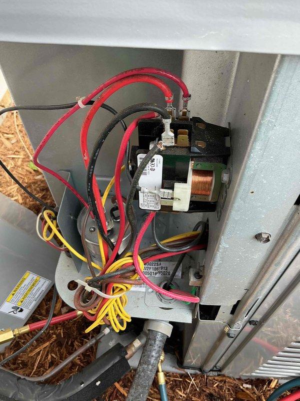 Completed comprehensive air conditioning tune-up including inspection of electrical components, contactor, and wiring connections within the unit's electrical compartment. Verified system pressures using manifold gauges and inspected condenser coil fins and exterior housing for proper operation. All components found to be functioning within normal parameters.