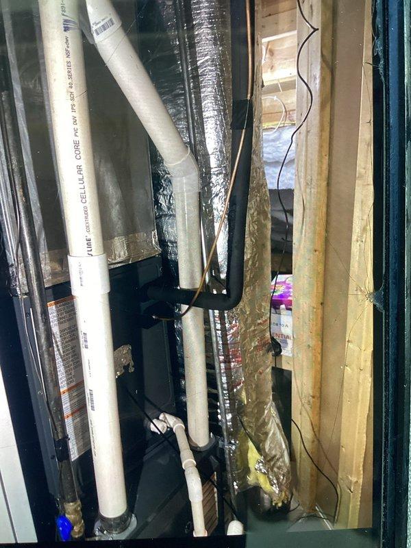 Responded to no cooling complaint with 6 PM arrival. Upon inspection, accessed HVAC system through interior wall chase where flexible ductwork and PVC drain line were observed running vertically through framing. System evaluated and cooling issue resolved during service call.