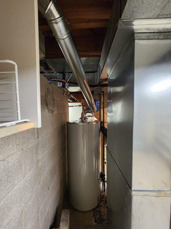 Installed 75-gallon residential water heater in basement utility area. Connected all supply and discharge plumbing lines with copper piping and appropriate brass fittings, installed expansion tank, and routed metallic vent pipe through floor joists to ensure proper exhaust ventilation. Unit tested and operational upon completion.