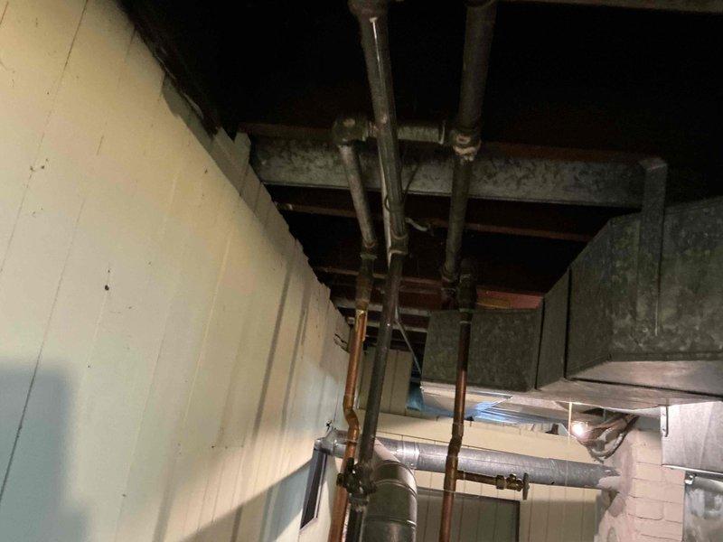 Completed estimate for water heater replacement in basement mechanical room. Existing unit showing signs of leakage requiring immediate replacement. Assessed installation area including existing copper piping connections, shut-off valves, and surrounding HVAC infrastructure to determine replacement specifications and material requirements.