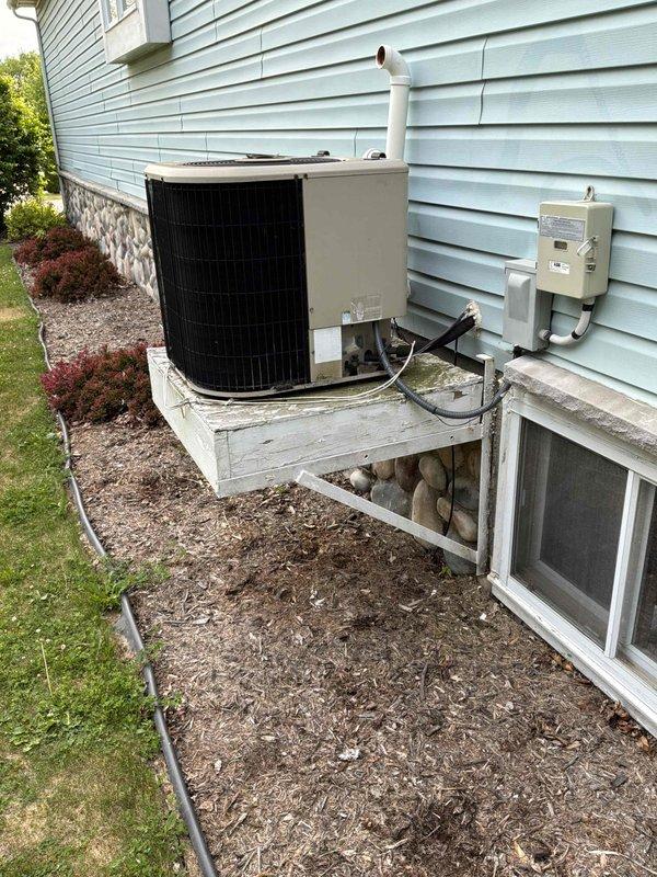 Completed estimate for full HVAC system replacement including natural gas furnace located in basement utility closet and outdoor air conditioning unit. Existing furnace showed signs of wear after limping through winter season. Assessed current installation configuration with furnace positioned in basement closet space with cylindrical ductwork elbow and outdoor condensing unit mounted on elevated white platform against house exterior with proper electrical disconnect and PVC condensate drainage. Provided pricing for complete system replacement with promotional upgrade package for air conditioning unit when purchased together with new furnace system.