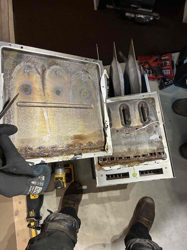 Completed warranty replacement of secondary heat exchanger on residential HVAC unit. Disassembled existing unit, removed failed heat exchanger showing significant corrosion and buildup, and installed new replacement component. Reassembled unit, tested all connections and controls, and verified proper system operation before completing service call.