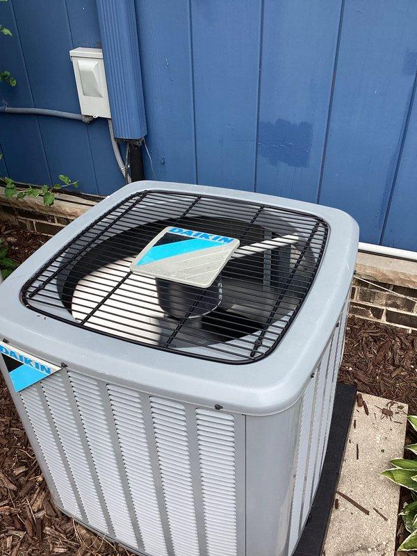 # HVAC Service Report - No Cooling Issue

## Work Performed

Responded to service call for air conditioning system not cooling properly, with recurring issue noted each spring season. Unit was installed in September 2020 and remains under parts and labor warranty coverage.

Upon arrival, performed comprehensive system evaluation of the outdoor condensing unit. Conducted visual inspection of the condenser, which is properly positioned on concrete pad with appropriate clearances. Verified electrical disconnect box and conduit connections at exterior wall mounting location. Checked fan operation and airflow through top grill assembly.

Inspected condenser coil fins for blockage, dirt accumulation, or debris that could restrict airflow and reduce cooling capacity. Examined refrigerant lines for proper insulation and signs of leakage. Verified unit is sitting level on vibration-dampening pad to ensure proper drainage and operation.

Based on the recurring springtime nature of the cooling is