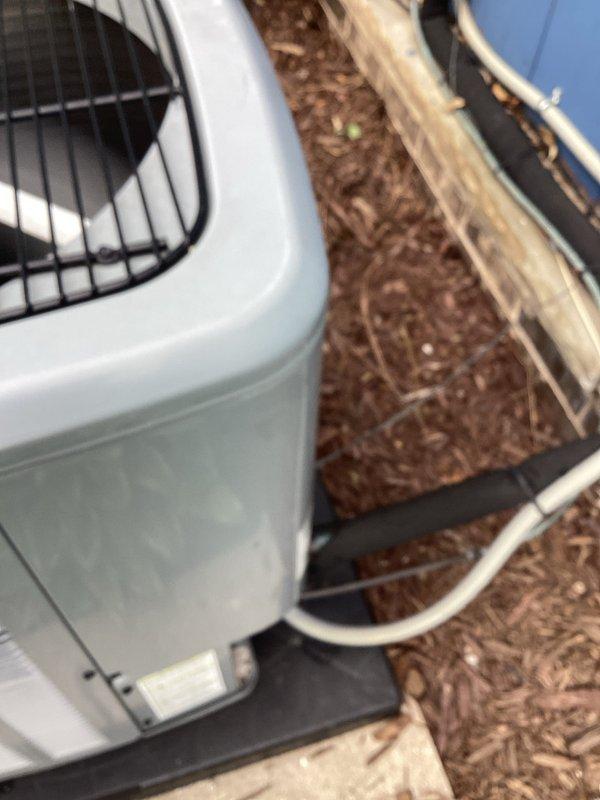 # HVAC Service Report - No Cooling Issue

## Work Performed

Responded to service call for air conditioning system not cooling properly, with recurring issue noted each spring season. Unit was installed in September 2020 and remains under parts and labor warranty coverage.

Upon arrival, performed comprehensive system evaluation of the outdoor condensing unit. Conducted visual inspection of the condenser, which is properly positioned on concrete pad with appropriate clearances. Verified electrical disconnect box and conduit connections at exterior wall mounting location. Checked fan operation and airflow through top grill assembly.

Inspected condenser coil fins for blockage, dirt accumulation, or debris that could restrict airflow and reduce cooling capacity. Examined refrigerant lines for proper insulation and signs of leakage. Verified unit is sitting level on vibration-dampening pad to ensure proper drainage and operation.

Based on the recurring springtime nature of the cooling is
