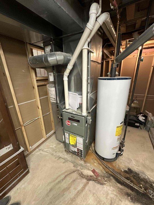 Conducted comprehensive HVAC system evaluation for non-functional air conditioning unit and existing furnace installation. Assessed current equipment condition, including dark gray furnace unit with associated PVC venting and ductwork configuration in unfinished basement mechanical room, as well as attic-mounted duct system components. Documented existing system specifications, reviewed equipment age and efficiency ratings, and provided replacement estimate options for complete HVAC system upgrade to restore cooling functionality and optimize heating performance.