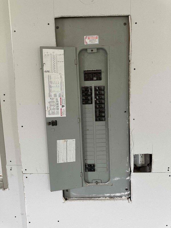 Completed estimate for mini-split installation in garage to provide heating and cooling capabilities. Evaluated existing electrical panel capacity and breaker configuration to determine adequate power supply for proposed ductless system, documenting current electrical infrastructure with panel photos showing available breaker spaces and main service capacity.