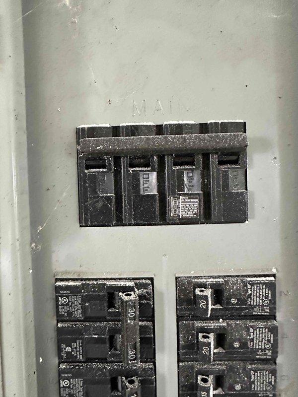 Completed estimate for mini-split installation in garage to provide heating and cooling capabilities. Evaluated existing electrical panel capacity and breaker configuration to determine adequate power supply for proposed ductless system, documenting current electrical infrastructure with panel photos showing available breaker spaces and main service capacity.