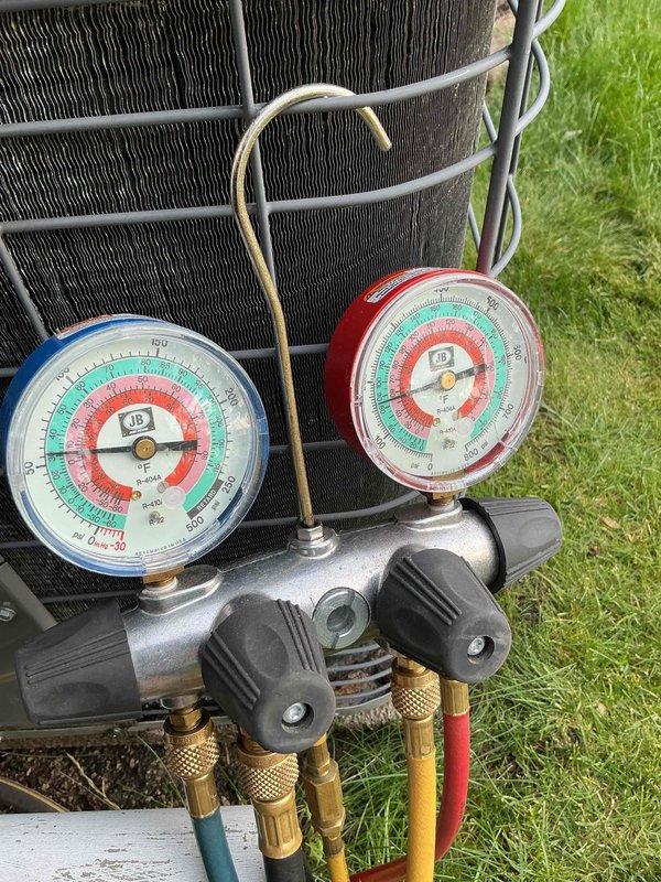 Responded to service call for odor coming from furnace. Upon arrival, performed comprehensive diagnostic evaluation and system tune-up as requested. Conducted electrical testing on outdoor unit using digital multimeter, measuring voltage and amperage at the contactor assembly to verify proper operation. All electrical connections showed normal readings with voltage at 75.7V on tested circuit. Inspected and tested all wire terminations including multi-phase connections to ensure secure contact points.

Proceeded with refrigerant system evaluation using manifold gauge set to measure operating pressures on both high and low sides of the system. Connected gauges to service ports and monitored system performance. All pressure readings fell within manufacturer specifications for current ambient conditions. Verified proper refrigerant charge and system operation through pressure analysis.

Completed visual inspection of outdoor condensing unit including condenser coil condition, electrical co
