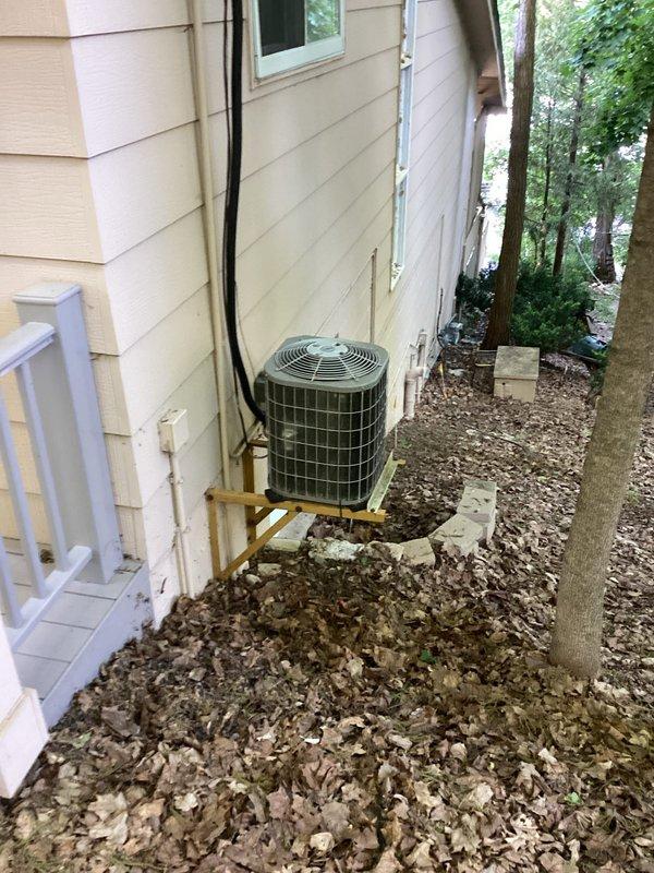 Responded to no cooling complaint with attic unit freezing over. Upon inspection, found residential split system HVAC equipment located in attic space with outdoor condensing unit mounted on exterior platform. Documented equipment information including manufacturer data from unit labels for aging system over 10 years old. Assessed frozen evaporator coil condition and identified potential causes including restricted airflow, low refrigerant charge, or failed blower motor operation. Verified ductwork connections and insulation integrity in attic installation. Inspected outdoor unit for proper operation, checked refrigerant line insulation running along exterior wall, and evaluated condensate drainage system. Provided customer with equipment age assessment, diagnostic findings, and repair recommendations to restore cooling function and prevent future freeze-up conditions.