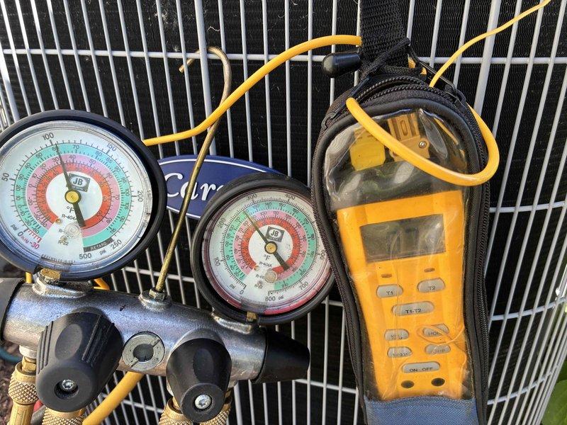 Completed prepaid membership cooling maintenance visit on residential HVAC system. Performed comprehensive system diagnostics using manifold gauges and digital meter to verify refrigerant pressures and temperatures. Inspected indoor furnace unit with access panel removed, checking gas valve assembly, electrical connections, and all internal components for proper operation and safety compliance. All systems tested and operating within normal parameters.