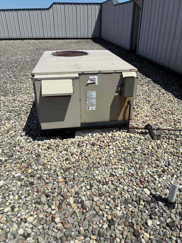 Conducted estimate for replacement of non-operational 4-ton Lennox rooftop unit on single-story commercial building. Assessed existing RTU showing signs of weathering and corrosion, documented equipment condition and rooftop access via built-in ladder with hatch, and determined crane will be required for removal and installation due to rooftop configuration and equipment weight.