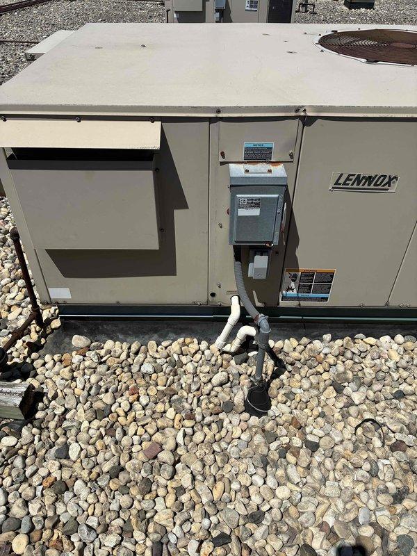 Conducted estimate for replacement of non-operational 4-ton Lennox rooftop unit on single-story commercial building. Assessed existing RTU showing signs of weathering and corrosion, documented equipment condition and rooftop access via built-in ladder with hatch, and determined crane will be required for removal and installation due to rooftop configuration and equipment weight.