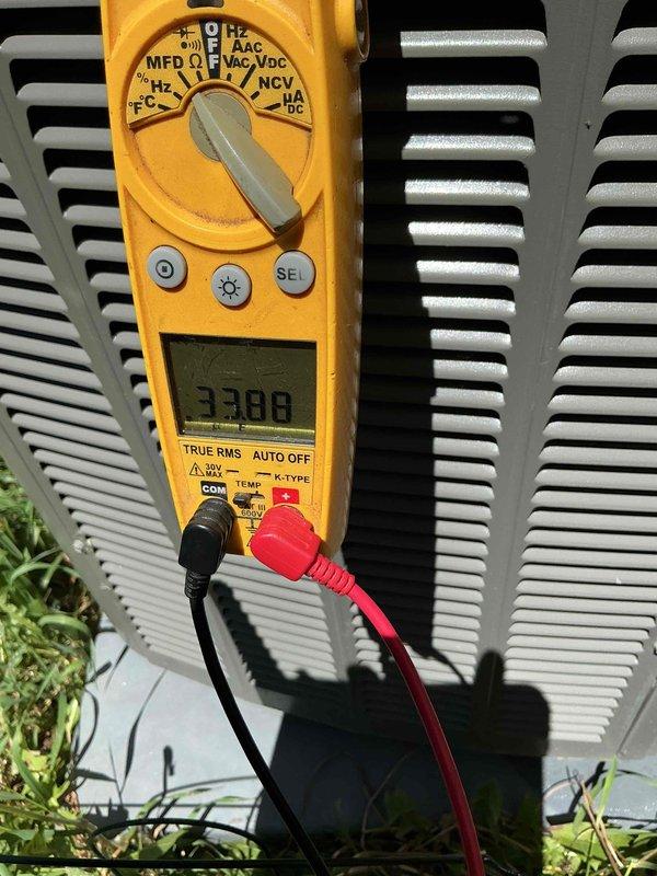 # HVAC Maintenance Report

Completed routine cooling season preventive maintenance visit per membership agreement. Performed comprehensive system inspection and diagnostic testing on residential air conditioning unit. Utilized digital clamp meter to measure electrical parameters, recording compressor amperage draw of 33.88 amps. Verified proper electrical operation and confirmed readings within manufacturer specifications.

Connected refrigerant manifold gauge set with blue low-side and red high-side gauges to service ports. Measured system pressures to evaluate refrigerant charge and overall system performance. All pressure readings fell within normal operating ranges for ambient conditions. Inspected condenser unit exterior components including coil fins, which showed good condition with no significant debris accumulation or damage. 

System operating efficiently with no deficiencies noted. All equipment functioning as designed. Preventive maintenance service completed successfully.