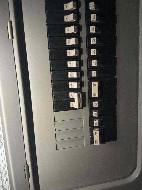 Conducted on-site assessment for non-operational air conditioning system and natural gas furnace replacement in basement location. Evaluated existing electrical infrastructure and panel capacity to ensure adequate power supply for new HVAC equipment installation. Documented current electrical panel configuration showing available breaker spaces and verified proper circuit protection for planned system upgrade.