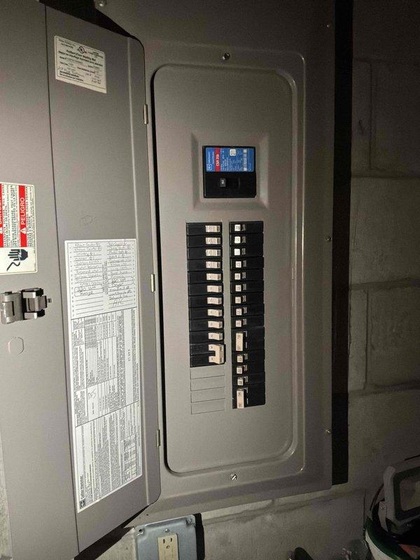Conducted on-site assessment for non-operational air conditioning system and natural gas furnace replacement in basement location. Evaluated existing electrical infrastructure and panel capacity to ensure adequate power supply for new HVAC equipment installation. Documented current electrical panel configuration showing available breaker spaces and verified proper circuit protection for planned system upgrade.