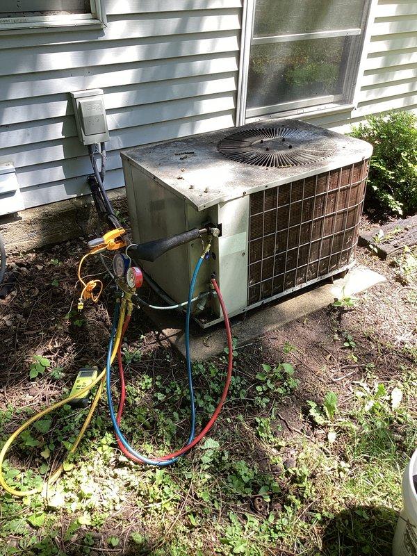 Responded to no cooling complaint on 10+ year old residential air conditioning system. Upon arrival, found first floor thermostat with non-functioning buttons affecting system operation. Accessed basement furnace and outdoor condensing unit to perform diagnostic testing. Connected manifold gauges to condenser service ports to check refrigerant pressures and system performance. Evaluated airflow, temperature differential, and overall system operation. Identified thermostat malfunction as primary issue preventing proper cooling on first floor. Recommended thermostat replacement to restore full system functionality and proper temperature control.