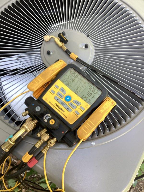 Completed full installation of new air conditioning system and evaporator coil at residential property. Outdoor condensing unit was set on ground-level pad, refrigerant lines were run and connected to new indoor coil mounted above existing Lennox furnace, and all electrical connections were established. System was charged with refrigerant, leak-tested at all connection points, and performance verified using digital manifold gauges with measured readings confirming proper operation within manufacturer specifications.