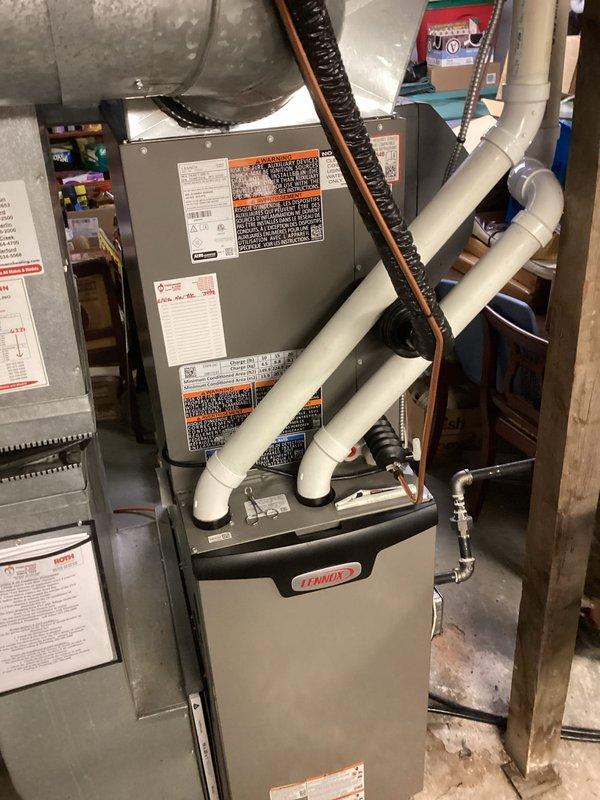 Completed full installation of new air conditioning system and evaporator coil at residential property. Outdoor condensing unit was set on ground-level pad, refrigerant lines were run and connected to new indoor coil mounted above existing Lennox furnace, and all electrical connections were established. System was charged with refrigerant, leak-tested at all connection points, and performance verified using digital manifold gauges with measured readings confirming proper operation within manufacturer specifications.