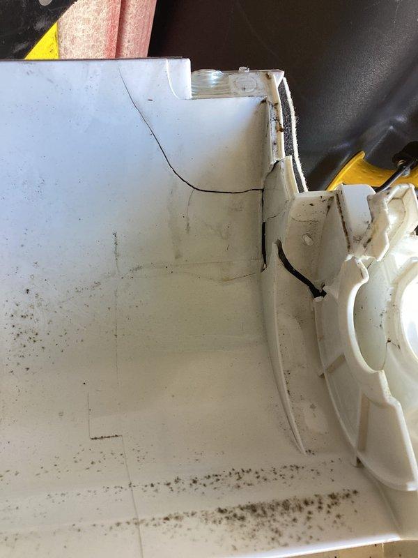 Responded to service call for ductless mini-split system maintenance. Upon arrival, inspected the wall-mounted indoor air handler unit and discovered significant debris accumulation in the condensate drain pan, with dark staining and buildup along the bottom and edges indicating drainage concerns. Cleaned the drain pan thoroughly, removing dirt and debris to restore proper condensate drainage function and prevent potential water overflow issues.