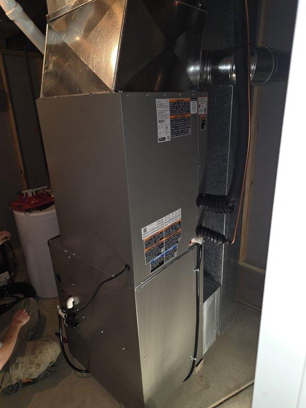 Completed full HVAC system installation including new furnace and air conditioning unit in basement utility area. Installed new electrical subpanel to provide dedicated power supply for AC system per code requirements. All equipment properly positioned, connected, and tested for optimal performance with ductwork integrated into existing infrastructure.