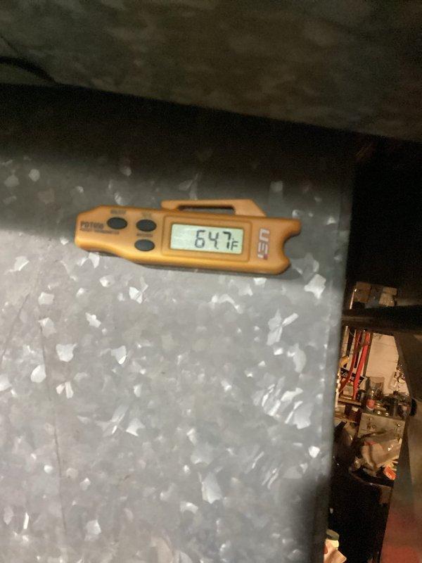 Responded to service call for continuously running HVAC system with 40+ year old equipment. Upon inspection, found evaporator coil severely frozen with heavy ice accumulation, measuring 64°F surface temperature. Diagnosed issue as likely caused by restricted airflow, low refrigerant charge, or failed control board preventing proper system cycling. Inspected outdoor unit control panel revealing disorganized wiring, aging capacitor, contactor, and transformer. Due to advanced age of equipment and extent of freeze-up, recommended system evaluation after thaw and potential replacement given the unit's age exceeding typical service life expectancy.
