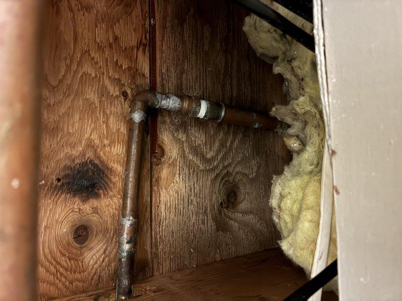 Diagnosed non-functional outdoor hose bib and associated shut-off valve. Inspection revealed failed interior shut-off valve with corroded copper piping connections within cabinet enclosure. Replaced defective shut-off valve assembly and repaired exterior hose bib mounting at foundation level, addressing water staining on siding caused by previous fixture failure. Tested system for proper operation and verified leak-free connections at all points.