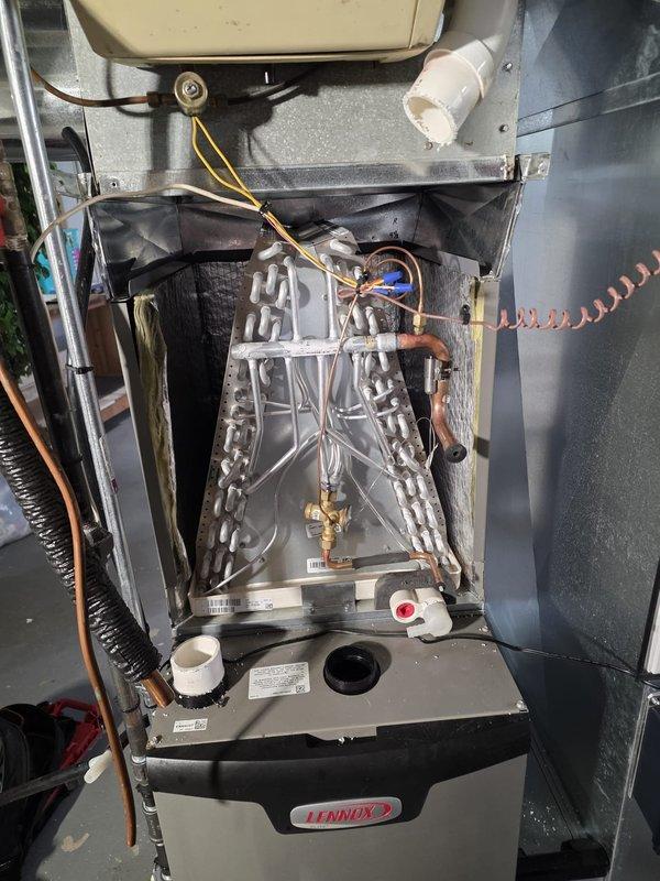Replaced failed evaporator coil (model CK40CT-30B-01) under warranty due to refrigerant leak in Lennox furnace system. Removed access panels, recovered remaining refrigerant, disconnected copper lines and electrical connections, installed new coil assembly, pressure tested system, evacuated to proper vacuum levels, and recharged with refrigerant to manufacturer specifications. Verified proper system operation with temperature differential readings and confirmed no leaks present.