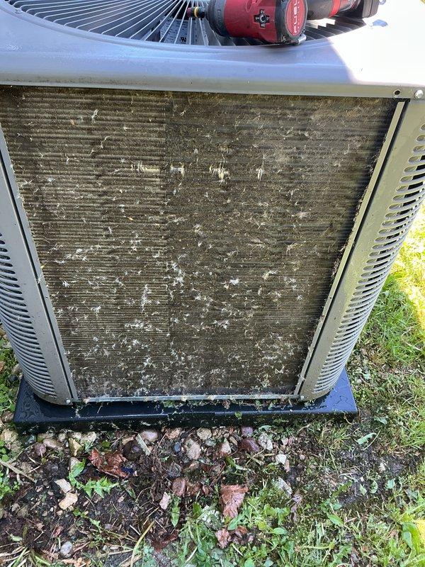 Completed preventative maintenance tune-up on Lennox air conditioning system. Upon arrival, found outdoor condenser coil heavily fouled with dirt, debris, pollen, and organic matter significantly restricting airflow through heat exchanger fins. Performed thorough coil cleaning to remove accumulated buildup and restore proper heat transfer efficiency. Cleared debris from base of unit and surrounding area. Completed full system inspection and operational testing to ensure proper cooling performance.