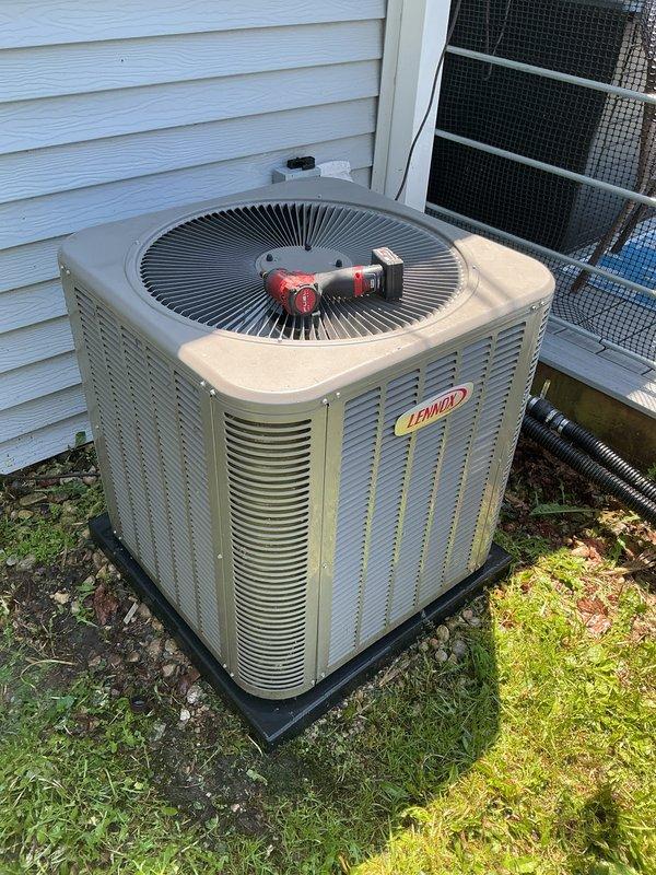 Completed preventative maintenance tune-up on Lennox air conditioning system. Upon arrival, found outdoor condenser coil heavily fouled with dirt, debris, pollen, and organic matter significantly restricting airflow through heat exchanger fins. Performed thorough coil cleaning to remove accumulated buildup and restore proper heat transfer efficiency. Cleared debris from base of unit and surrounding area. Completed full system inspection and operational testing to ensure proper cooling performance.