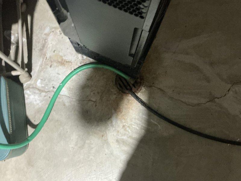 Responded to emergency service call for AC system with recurring refrigerant loss—system had previously required 2lbs of refrigerant that subsequently leaked out. Performed comprehensive system evaluation and provided replacement estimate for aging HVAC equipment located in basement utility area, documenting existing furnace and associated mechanical systems for customer consideration.