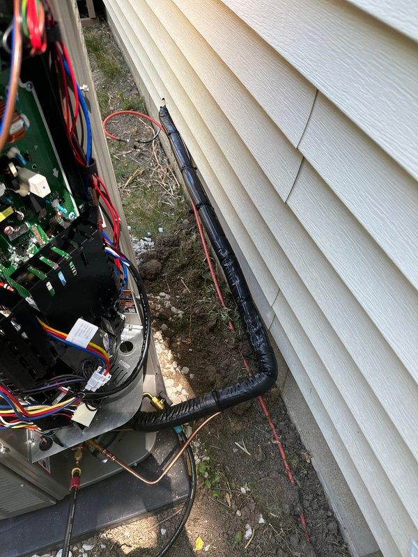 # HVAC Complete System Installation

Completed full residential HVAC system replacement including new furnace, air conditioning unit, and S40 programmable thermostat. Installed Patriot adapter for PVC venting connection and reused existing filter cabinet to maintain system efficiency. Routed copper refrigerant lines and electrical wiring through confined space between structure and equipment pad. Performed system startup, verified electrical connections at outdoor control panel, and conducted diagnostic testing. System pressures measured at 256 PSI using calibrated refrigeration gauge, confirming proper refrigerant charge and optimal operating parameters. All components tested and operational upon completion.
