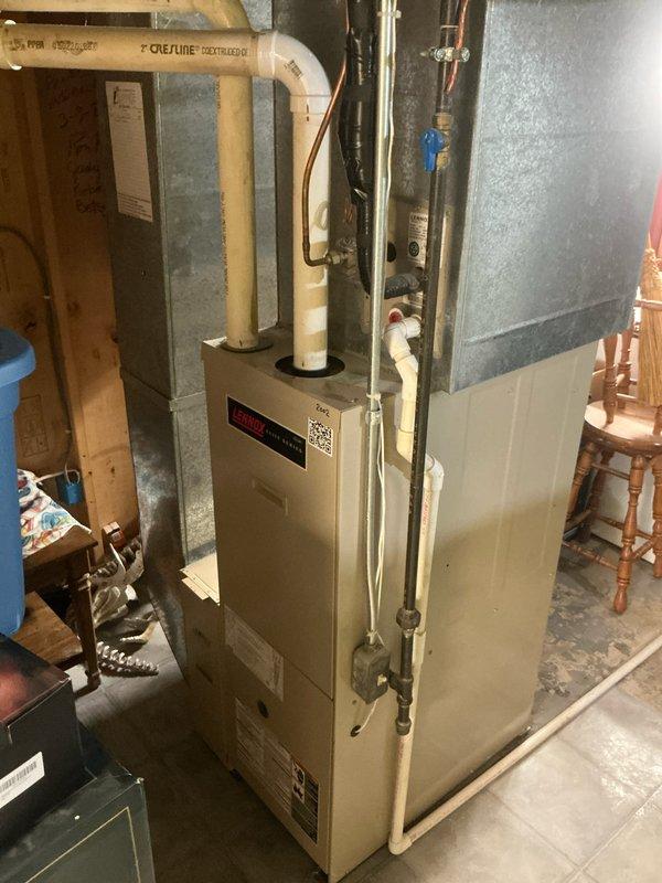 Responded to lead for non-functioning air conditioning system and provided comprehensive estimate for complete HVAC replacement including both furnace and AC unit. Assessed existing natural gas furnace installation in basement with associated ductwork, venting through white PVC pipes, and copper gas lines with shutoff valves. Evaluated current system configuration, measured equipment specifications, and documented existing setup with photographs to prepare accurate replacement proposal for new heating and cooling equipment.