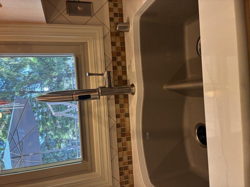 Connected new double-basin stainless steel kitchen sink to existing water supply lines and drain system, installing chrome faucet with contemporary single-handle design and ensuring proper sealing at all connection points. Inspected bathroom toilet for reported leak, verified proper operation of flush mechanism and water supply connections. All fixtures tested and confirmed operational with no active leaks detected at time of service completion.