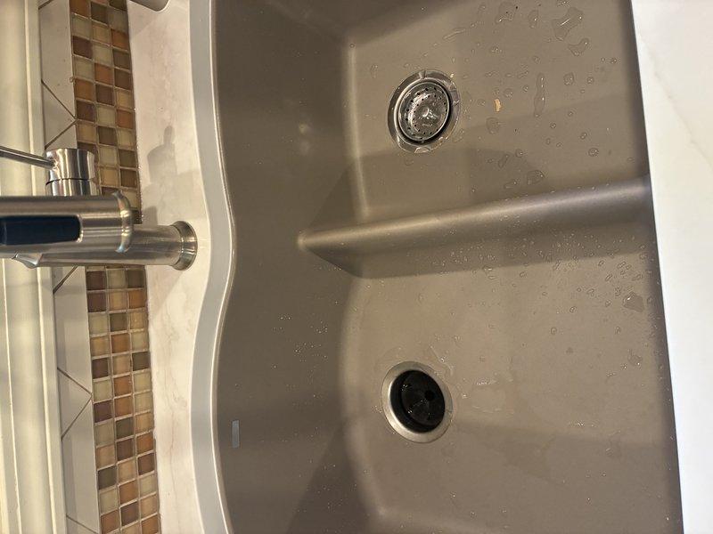 Connected new double-basin stainless steel kitchen sink to existing water supply lines and drain system, installing chrome faucet with contemporary single-handle design and ensuring proper sealing at all connection points. Inspected bathroom toilet for reported leak, verified proper operation of flush mechanism and water supply connections. All fixtures tested and confirmed operational with no active leaks detected at time of service completion.