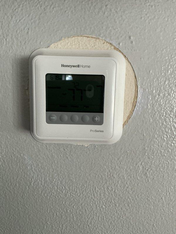 Responded to no cooling complaint following recent furnace installation. Upon arrival, found Honeywell Home ProSeries thermostat displaying 79°F setpoint with 58°F current temperature, indicating system not achieving desired cooling. Inspected outdoor condensing unit and verified proper installation. Diagnosed issue as thermostat wiring concern related to recent furnace replacement, likely due to improper common wire connection or thermostat configuration during heating system changeout. Corrected wiring connections at thermostat and air handler to ensure proper communication between components. Verified system operation with cooling cycle initiation and proper temperature response.