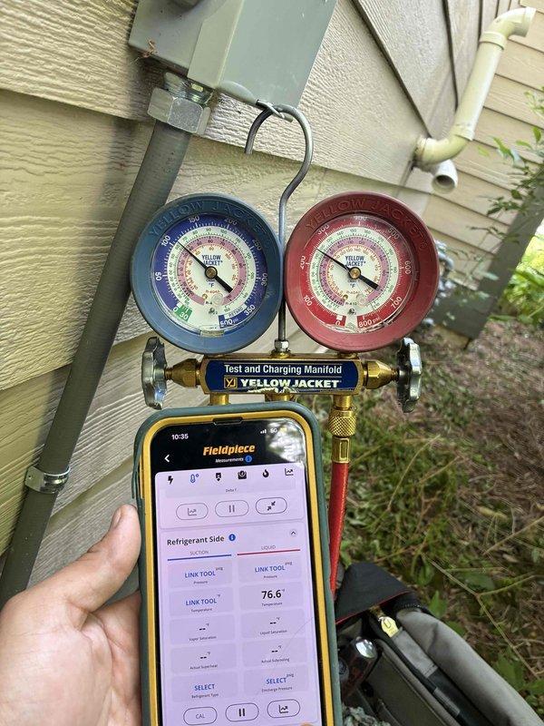 Completed routine cooling season tune-up and system inspection as part of recurring family membership service. Performed comprehensive diagnostics using digital testing equipment and manifold gauges to verify refrigerant pressures, temperatures, and overall system performance, recording 76.6°F at outdoor unit. Inspected indoor air handler unit in basement, checked all connections, verified proper insulation on refrigerant lines, and confirmed equipment labels and safety information were intact and legible. All systems operating within normal parameters with no issues identified.