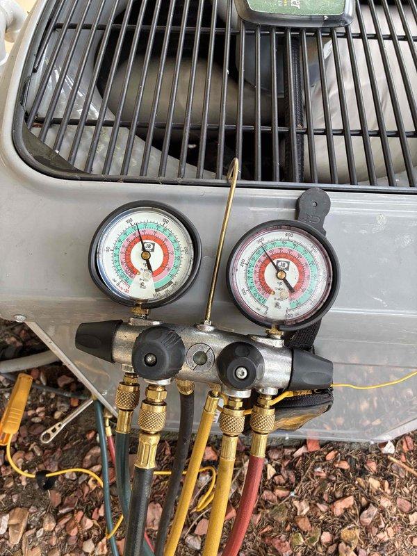 Completed routine cooling system maintenance as part of membership agreement. Performed comprehensive A/C tune-up including pressure diagnostics using manifold gauge set to verify refrigerant charge and system performance on outdoor condenser unit. Inspected indoor air handler components, noting dual-run capacitor rated at 454-517 MFD/370 VAC in good operating condition. Cleaned accumulated debris and organic matter from interior surfaces of air handler cabinet to ensure proper airflow and system efficiency. All system parameters found within normal operating specifications upon completion of preventive maintenance visit.
