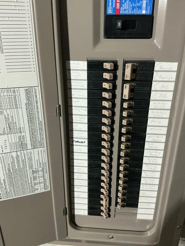 Responded to emergency AC service call and performed comprehensive system evaluation for replacement estimate. Documented existing electrical panel configuration showing dedicated furnace and AC circuits, and photographed current HVAC system access point with associated plumbing and mechanical connections to assess replacement requirements and provide accurate equipment sizing recommendations.