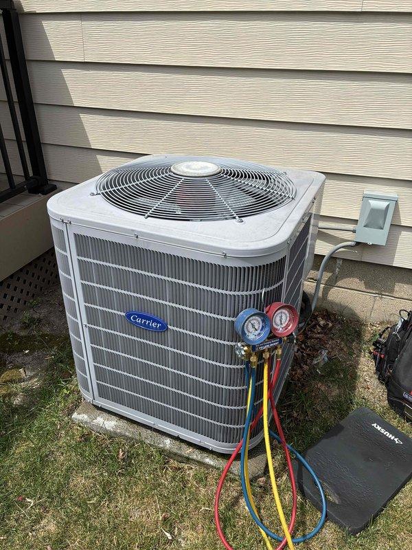 Performed comprehensive tune-up and diagnostic testing on Carrier outdoor condensing unit. Connected manifold gauge set to measure refrigerant pressures and verify system operating parameters within manufacturer specifications. Unit found operating properly with all components functioning as designed.