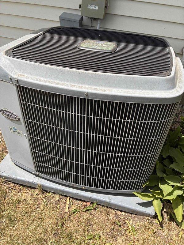 Completed preventative maintenance tune-up on Carrier outdoor condensing unit. Performed system diagnostics including temperature readings, verified evaporator coil operation at 58.1°F, inspected electrical disconnect and conduit connections, and confirmed unit operational status with normal airflow through condenser coils.
