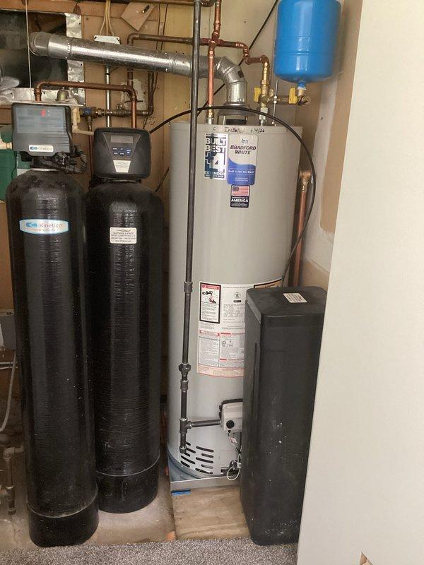 Completed full HVAC system installation including new air handler and air conditioning unit. Installed 40-gallon residential water heater with expansion tank and proper copper piping connections. Performed refrigerant charging and system commissioning, verifying pressures at 456.7 psig low side and 457.4 psig high side with proper superheat and subcooling values. All equipment installed to manufacturer specifications with appropriate venting, drainage, and electrical connections in basement utility area.