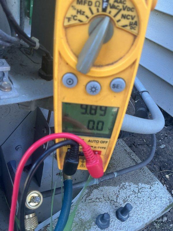 Completed comprehensive AC tune-up on outdoor condensing unit. Performed electrical diagnostics using digital multimeter, measuring capacitance readings of 369 MFD and verifying proper voltage levels at 0.4 volts on secondary circuits. All electrical components tested within normal operating parameters. Customer requested protective wrap for condenser unit due to previous squirrel damage to wiring; recommendation provided for rodent-resistant covering to prevent future pest intrusion.