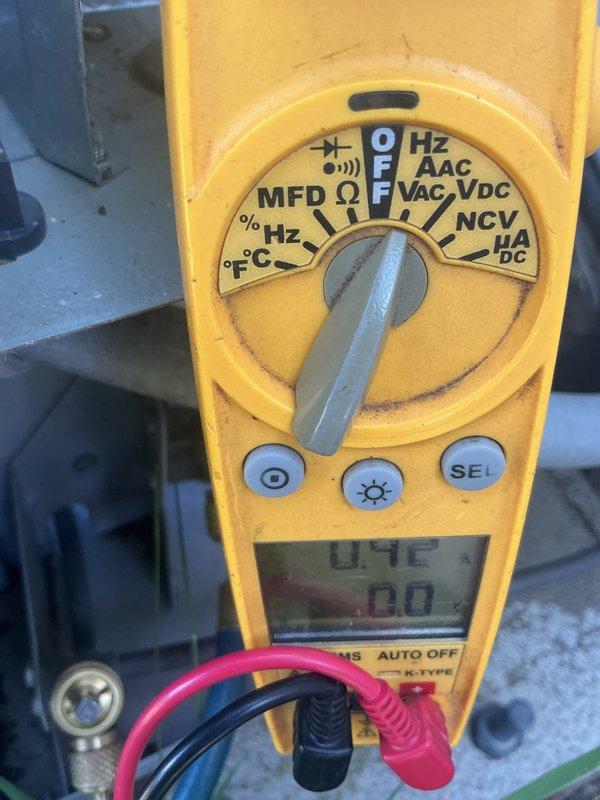 Completed comprehensive AC tune-up on outdoor condensing unit. Performed electrical diagnostics using digital multimeter, measuring capacitance readings of 369 MFD and verifying proper voltage levels at 0.4 volts on secondary circuits. All electrical components tested within normal operating parameters. Customer requested protective wrap for condenser unit due to previous squirrel damage to wiring; recommendation provided for rodent-resistant covering to prevent future pest intrusion.