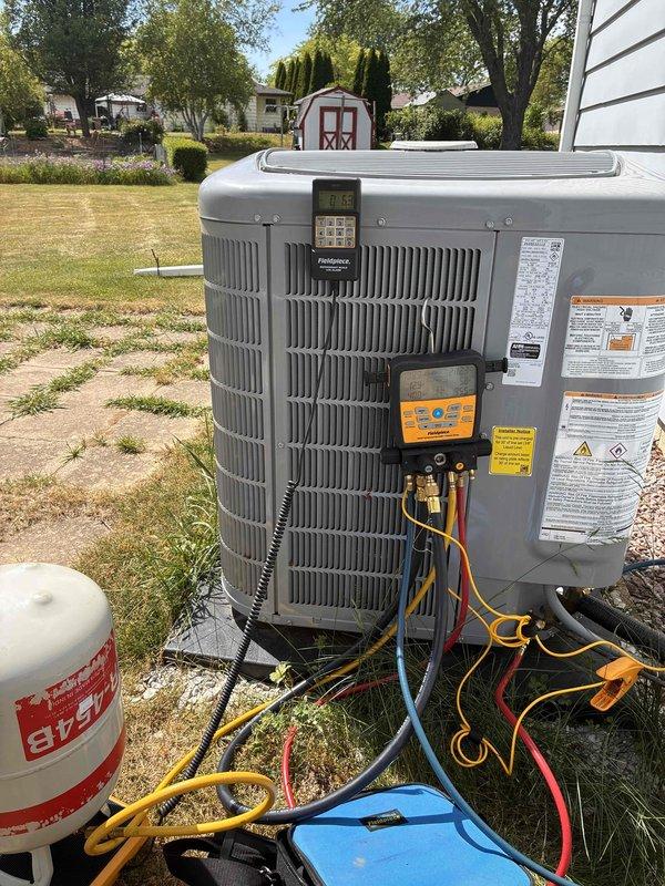 Attempted system startup on newly installed air conditioning unit but was unable to complete commissioning due to ambient temperature being too low for proper refrigerant charging and performance verification. Connected manifold gauges and diagnostic equipment to outdoor condensing unit in preparation for startup procedures. Observed indoor thermostat displaying 80°F room temperature in cooling mode with setpoint of 75°F. Will need to return when outdoor ambient temperature reaches approximately 80°F to properly charge system, verify refrigerant pressures, check superheat and subcooling values, and complete full startup checklist per manufacturer specifications.