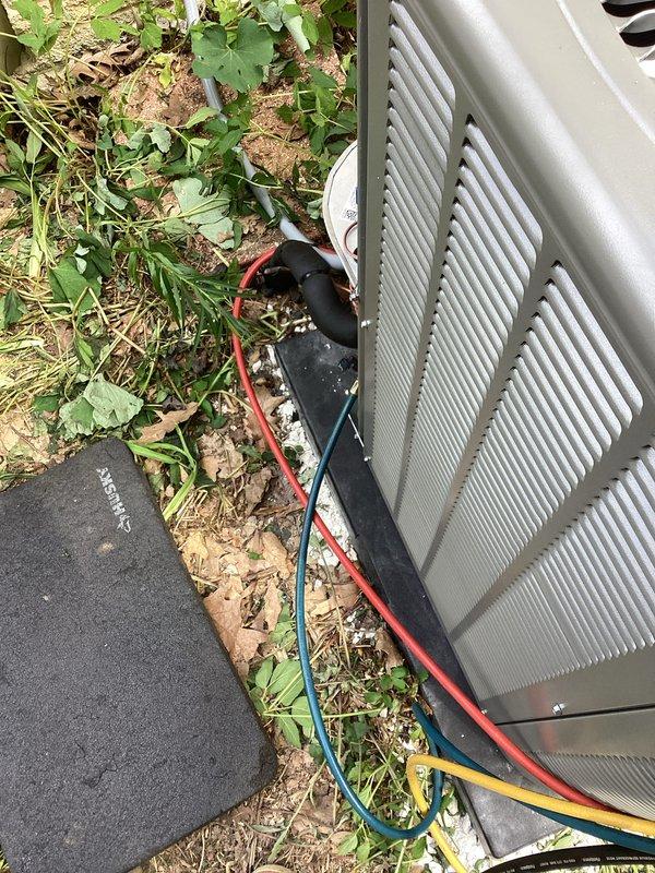 Completed installation of new outdoor air conditioning condenser unit and evaporator coil system. Unit was properly positioned on equipment pad, electrical connections were made with appropriate gauge wiring and color coding, refrigerant lines were installed and secured, and all components were tested for proper operation. System is operational and ready for use.