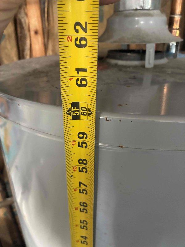 Responded to service call for 10-year-old 40-gallon water heater with failed pilot light. Conducted on-site assessment and documented existing unit dimensions and installation configuration for replacement estimate. Measured water heater height and clearances in mechanical space to ensure proper replacement unit sizing and compatibility with existing plumbing connections and venting system.