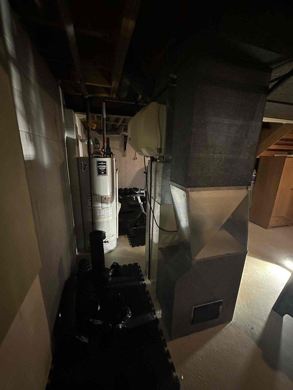 Completed estimate for full HVAC system replacement at residential property. Assessed non-functional furnace and underperforming air conditioning system in basement mechanical room. Documented existing Carrier equipment configuration, ductwork layout, and clearances for replacement unit specifications.