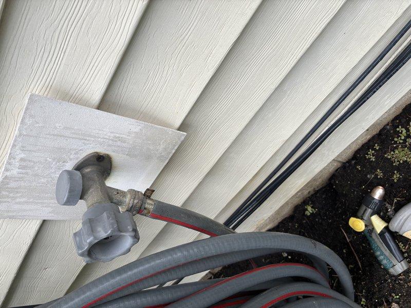 Responded to leaking outdoor spigot complaint. Located source of leak at exterior hose bib connection point and traced supply line to shut-off valve in utility room. Inspected copper supply piping and gate valve assembly, confirmed proper valve operation, and verified all connections were secure to resolve the leak issue.