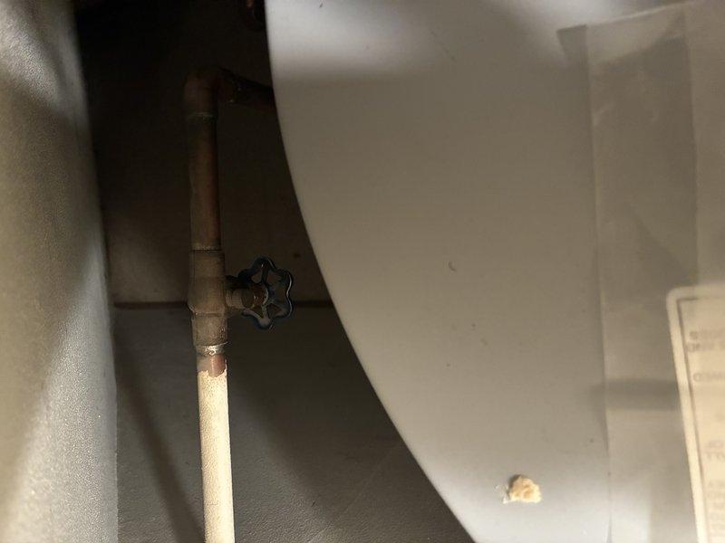 Responded to leaking outdoor spigot complaint. Located source of leak at exterior hose bib connection point and traced supply line to shut-off valve in utility room. Inspected copper supply piping and gate valve assembly, confirmed proper valve operation, and verified all connections were secure to resolve the leak issue.